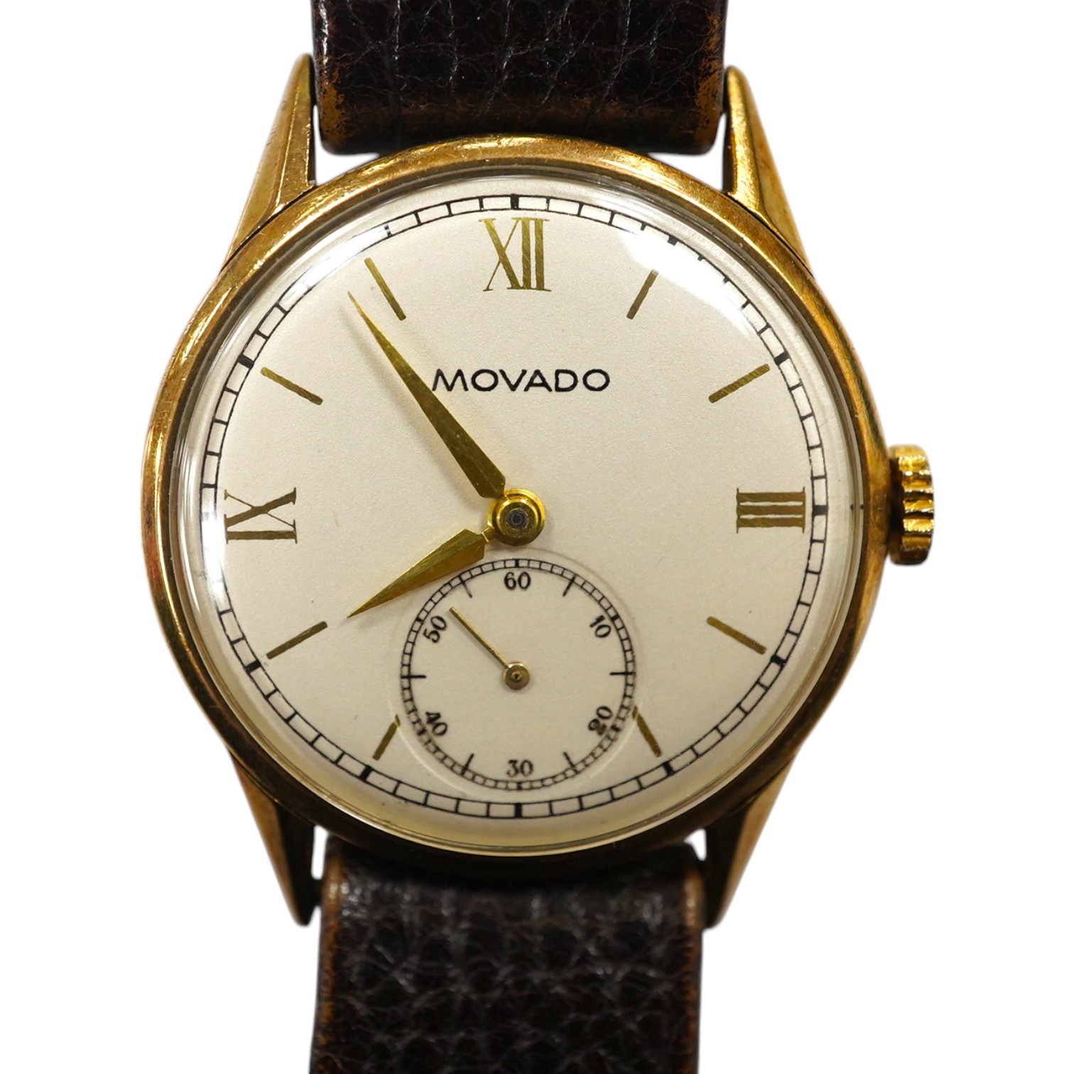 A gentleman's late 1930's 9ct gold Movado manual wind wrist watch, with baton and quarterly numerals and subsidiary seconds, case diameter 29mm, on an associated leather strap. Condition - fair